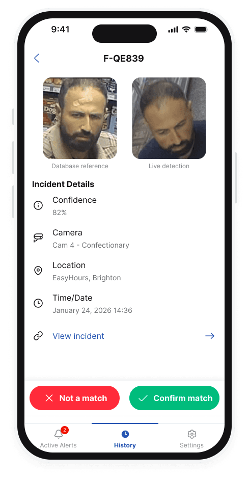 QuantumEye mobile app showing a face-recognition incident detail screen on an iPhone. The screen displays a database reference photo, a live detection capture, confidence score, camera identifier, location and timestamp, with 'Not a match' and 'Confirm match' action buttons at the bottom.