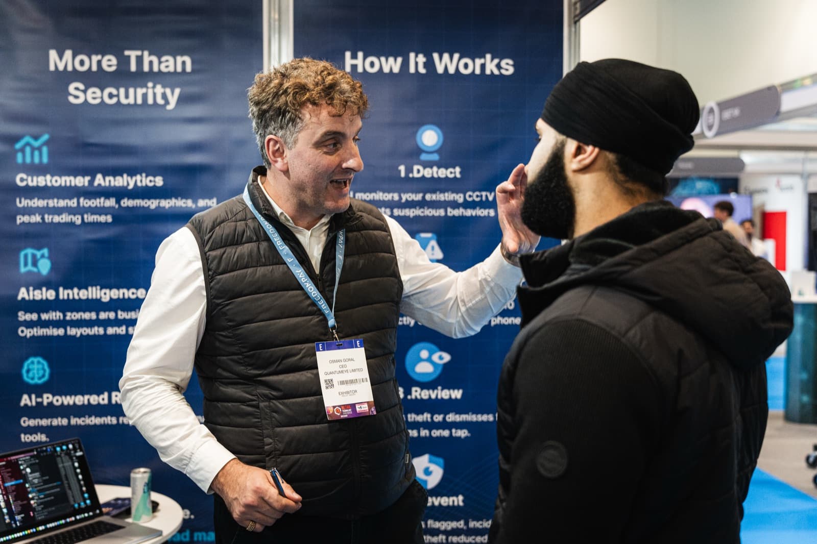 Osman Goral, QuantumEye CEO, walking a visitor through the detect, review and prevent workflow at a UK retail security exhibition.